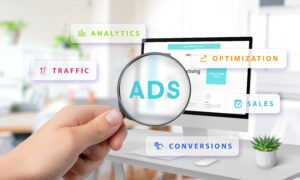 Magnifying glass highlighting Ads on computer screen with floating icons for analytics, traffic, optimization, sales, and conversions, symbolizing digital marketing